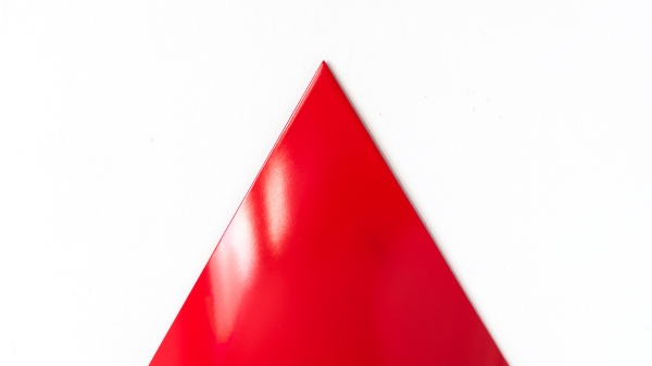 A red pylon against a white background
