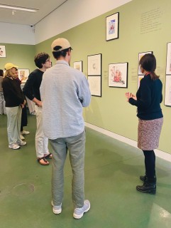 Students in conversation with the guide in the exhibition