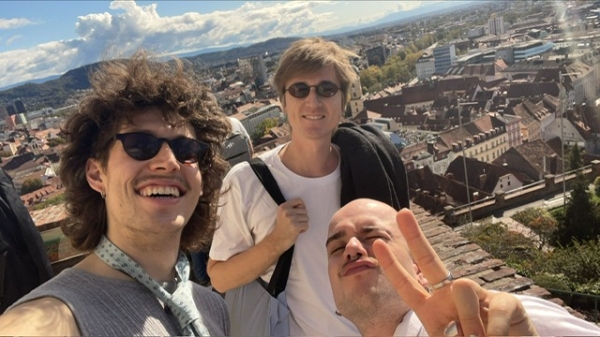 Three in coming students on the the top at the famous clock tower with an overview over Graz
